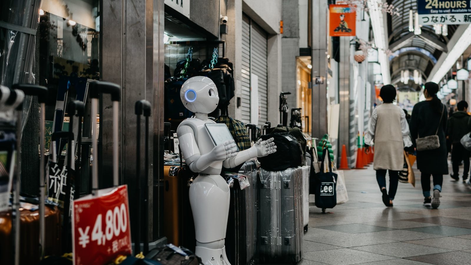 robot standing near luggage bags