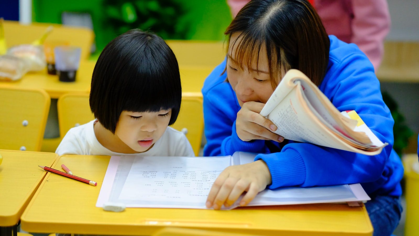 woman teaching girl