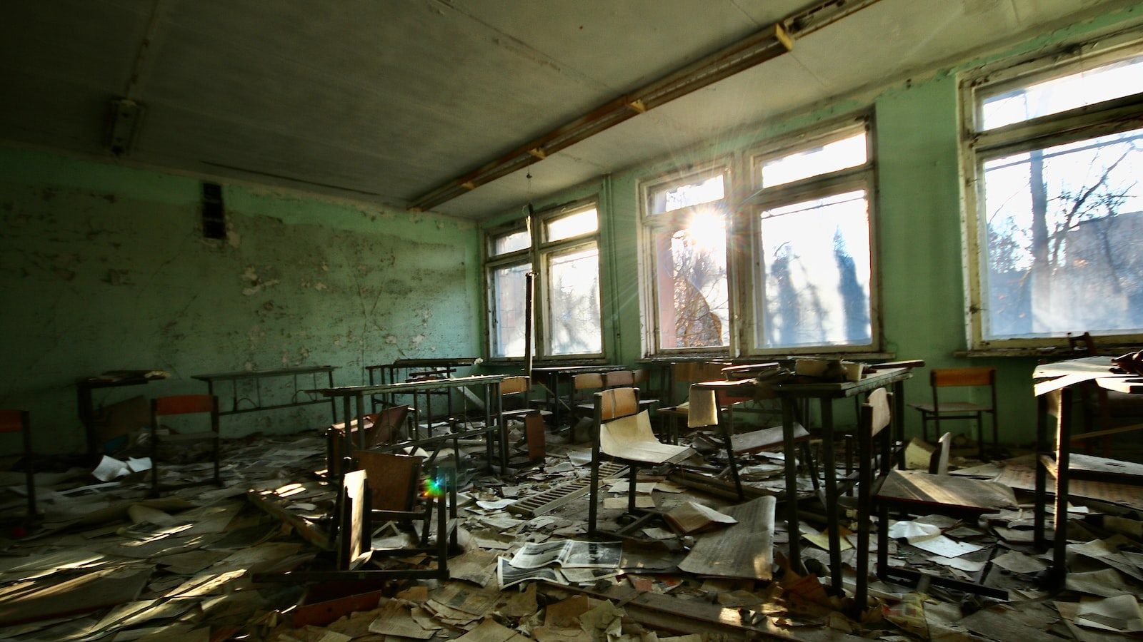 abandoned school with desk and chairs