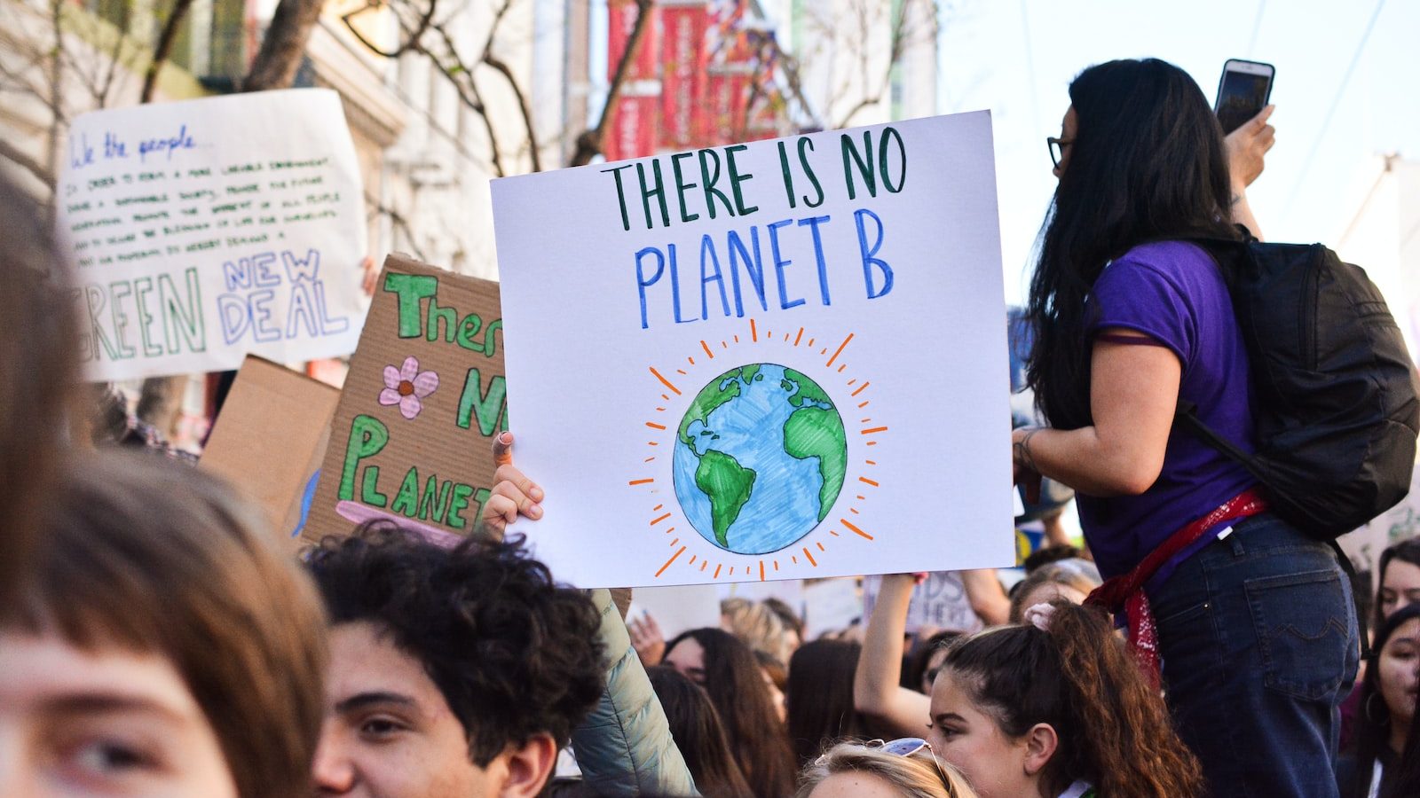 eco-awareness: person holding there is no planet b poster