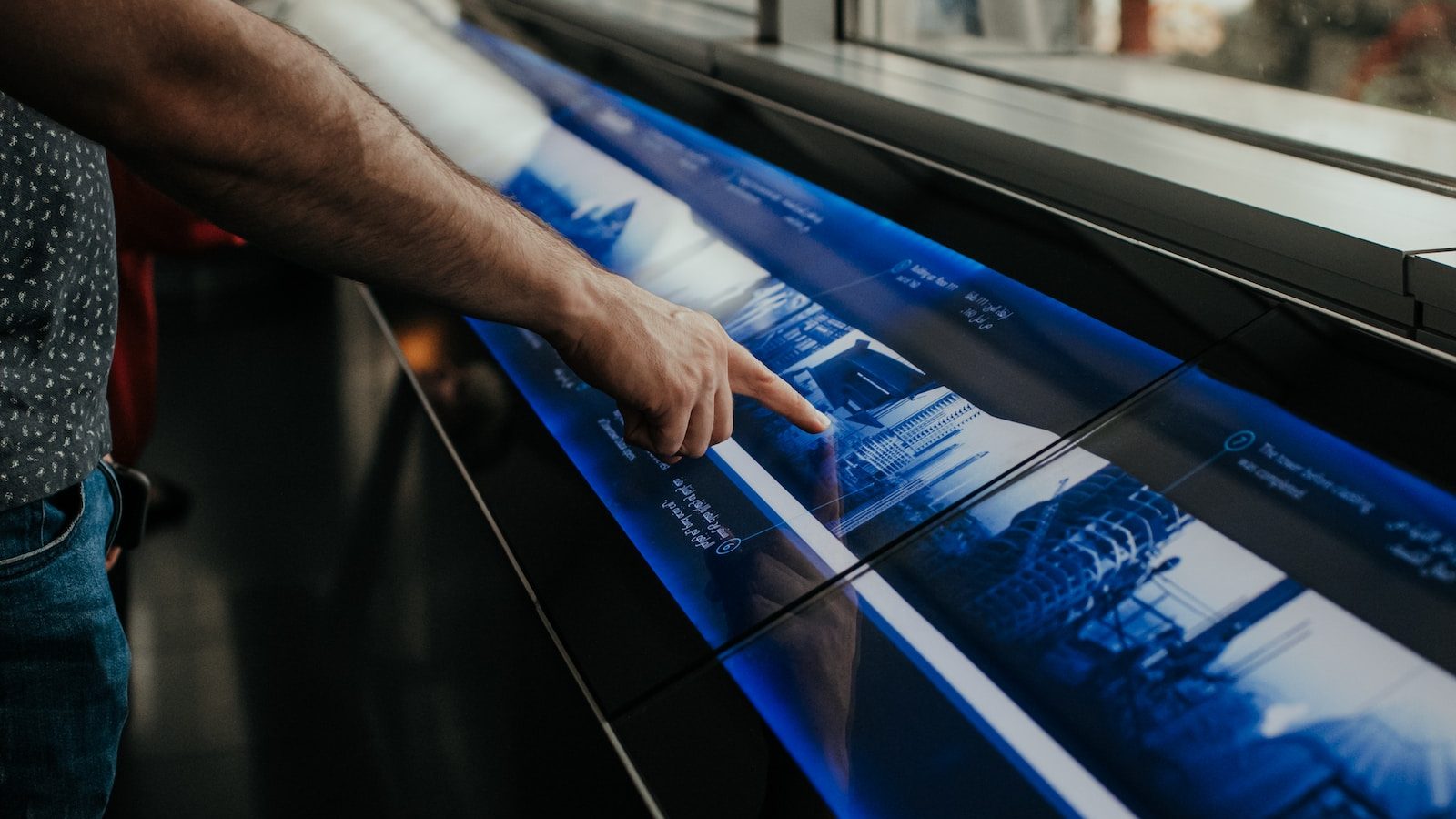 a man is pointing at a large poster