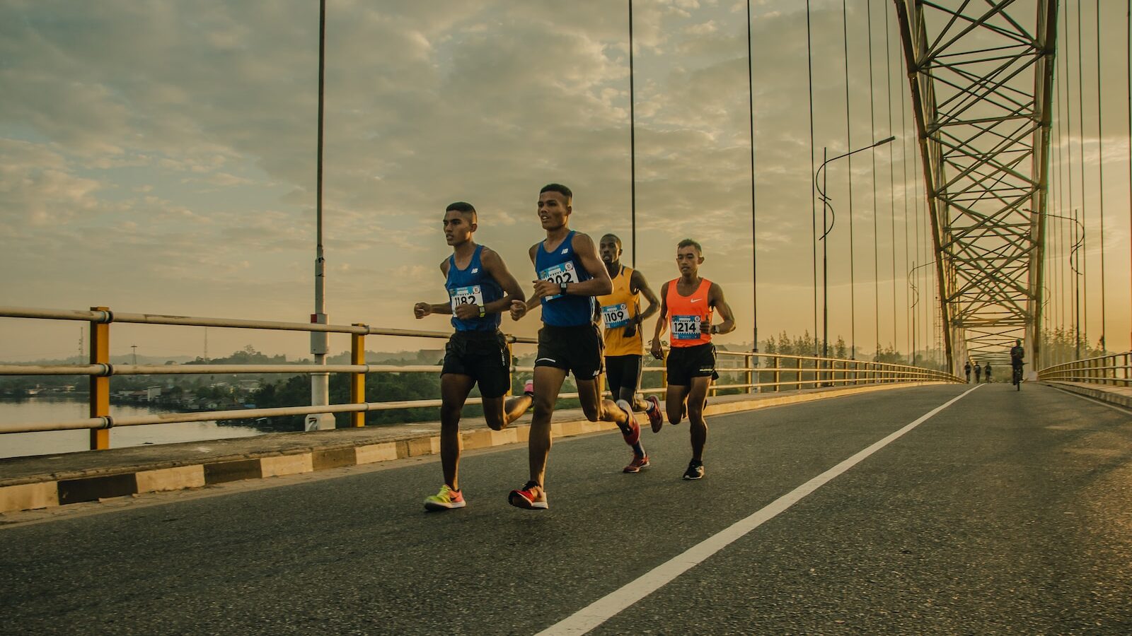 four men running on asphalt floor