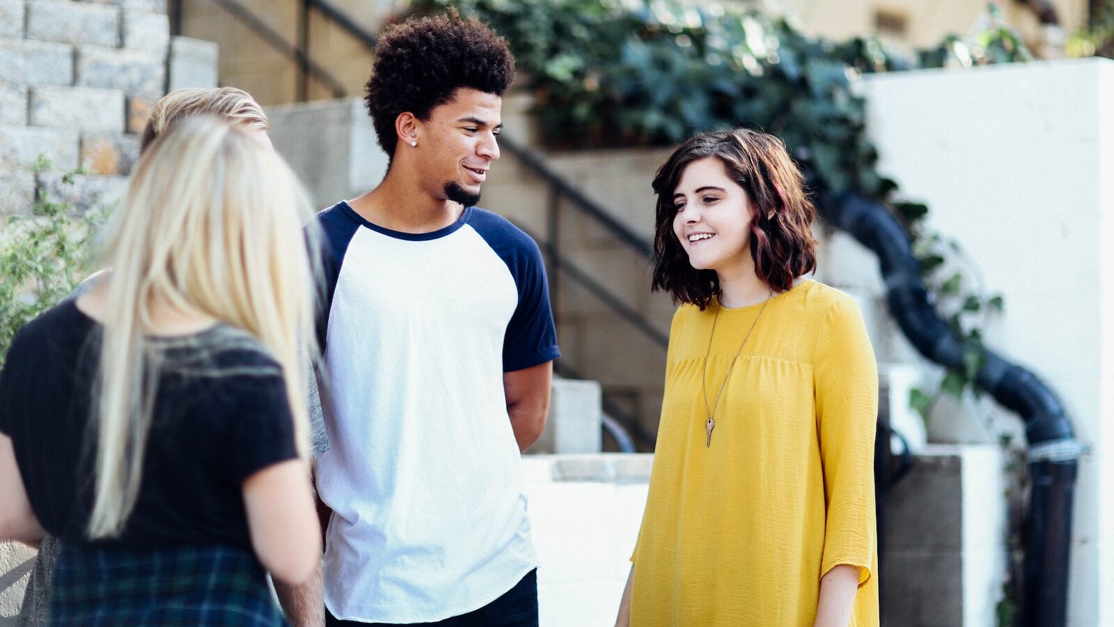 women and man talking outside the building