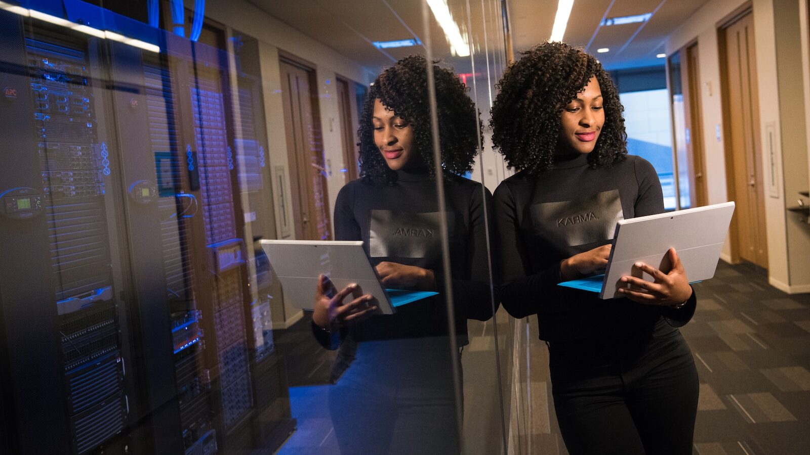 woman in black shirt using laptop computer