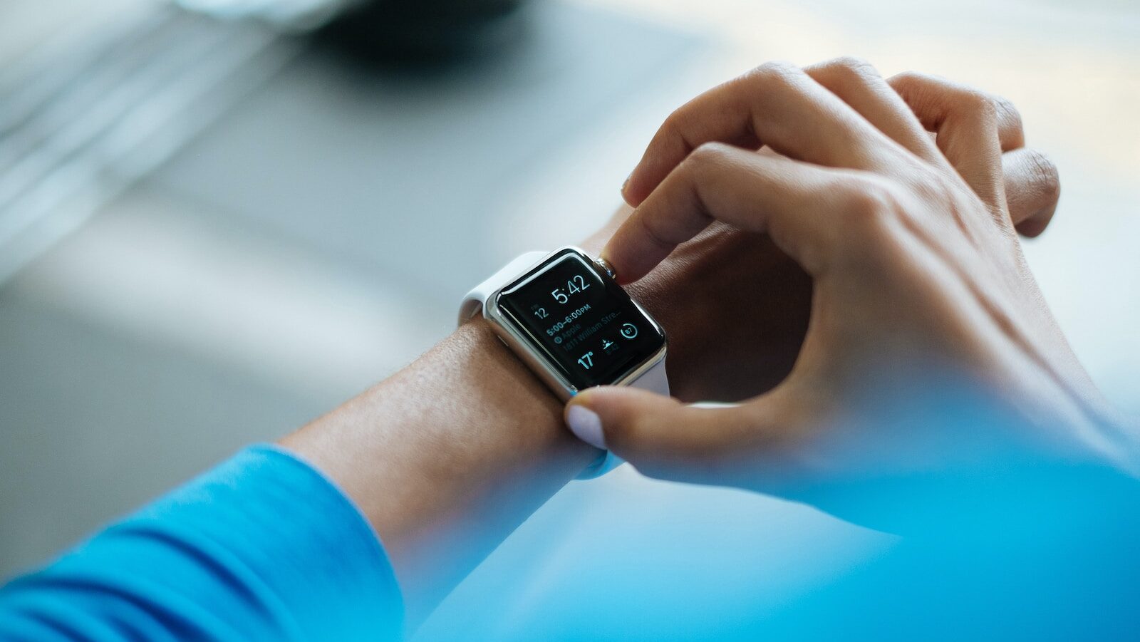 Health optimization: person clicking Apple Watch smartwatch