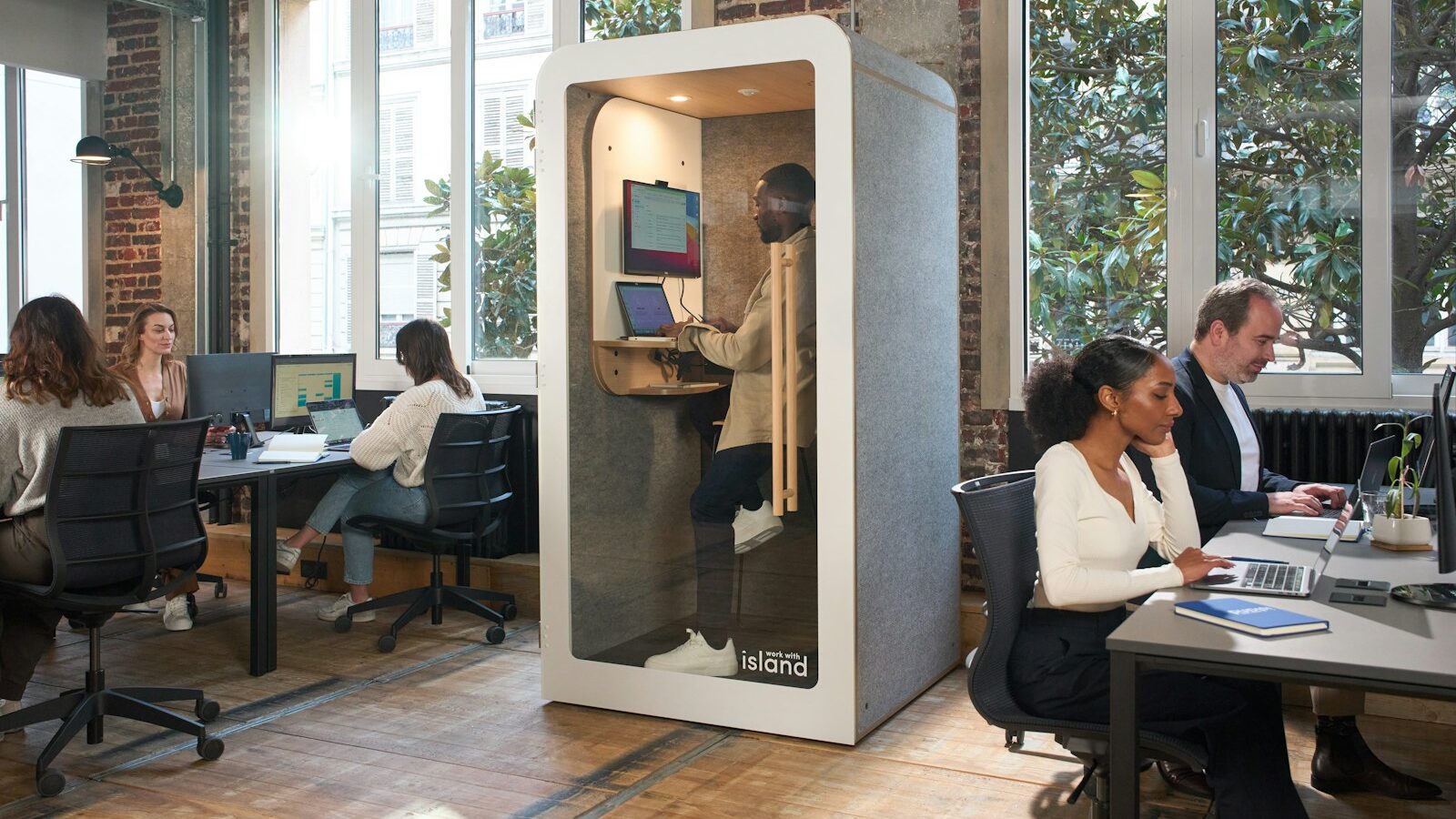A group of people sitting at desks in an office